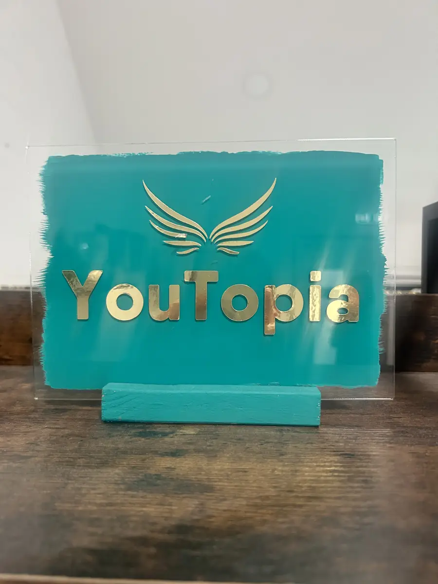 YouTopia teal and gold sign